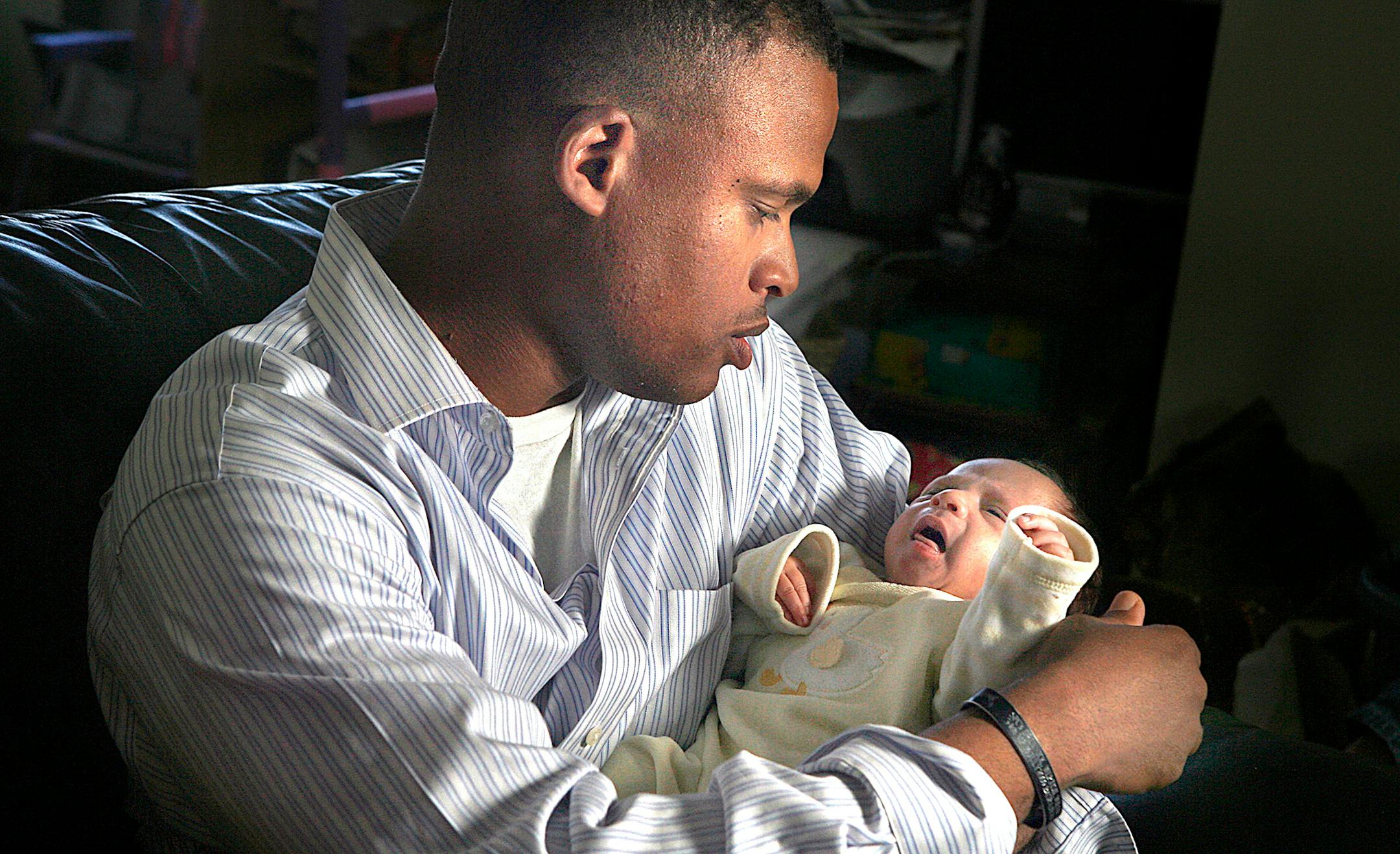Zachary Jones, who returned Sunday after a second tour of duty in Iraq with the Minnesota National Guard's 34th Infantry Division, held Zach Jr. at home in Eagan Tuesday. Jones missed his son's dramatic arrival Dec. 24 in a hospital parking lot during a snowstorm.