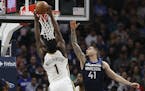 The Pelicans' Zion Williamson soared for a dunk against Timberwolves forward Juancho Hernangomez in the first half Sunday.