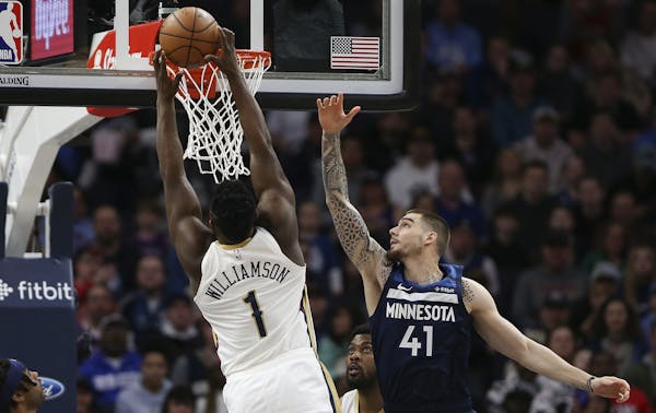 The Pelicans' Zion Williamson soared for a dunk against Timberwolves forward Juancho Hernangomez in the first half Sunday.