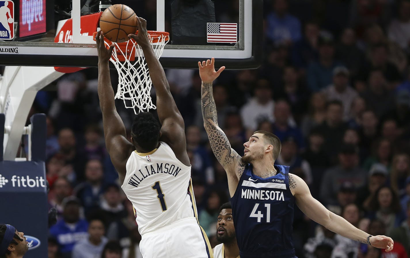 The Pelicans' Zion Williamson soared for a dunk against Timberwolves forward Juancho Hernangomez in the first half Sunday.