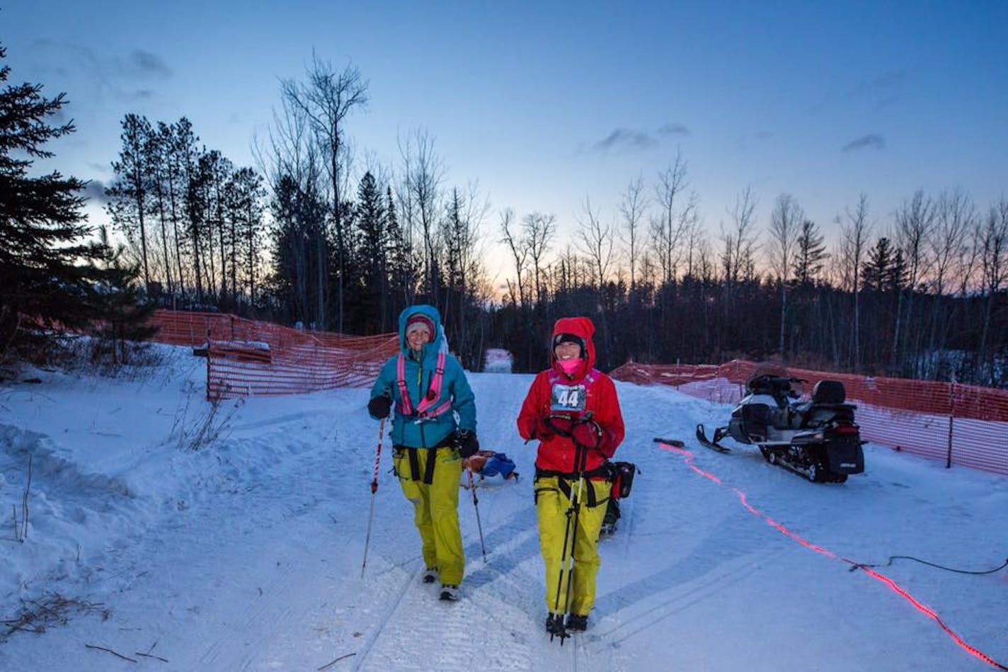 Kate Coward, left, and Kari Gibbons managed smiles Wednesday as they neared the finish line of the Arrowhead 135.