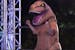 A competitor in a dinosaur costume challenges the obstacle course on "American Ninja Warrior."