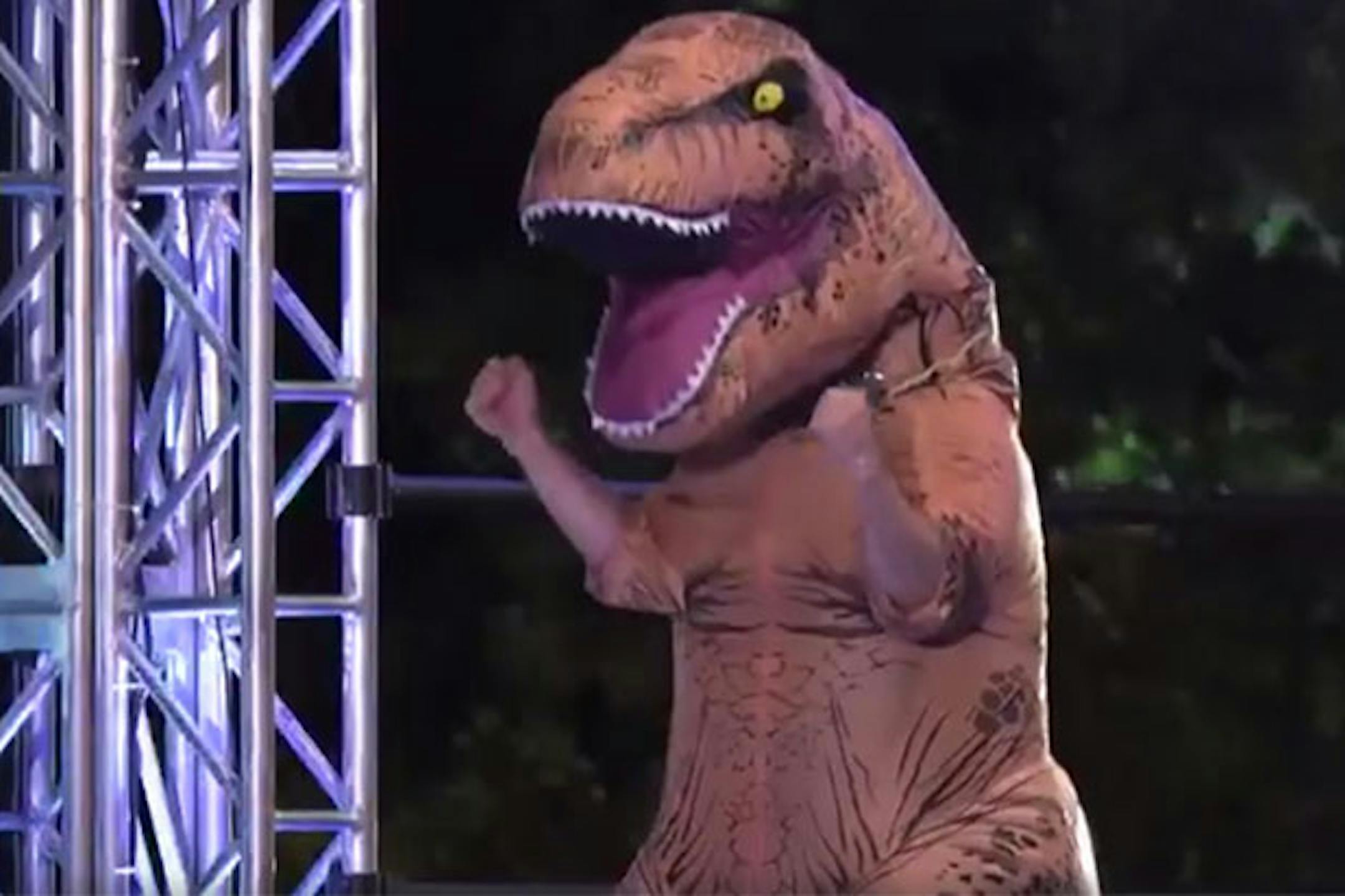 A competitor in a dinosaur costume challenges the obstacle course on "American Ninja Warrior."