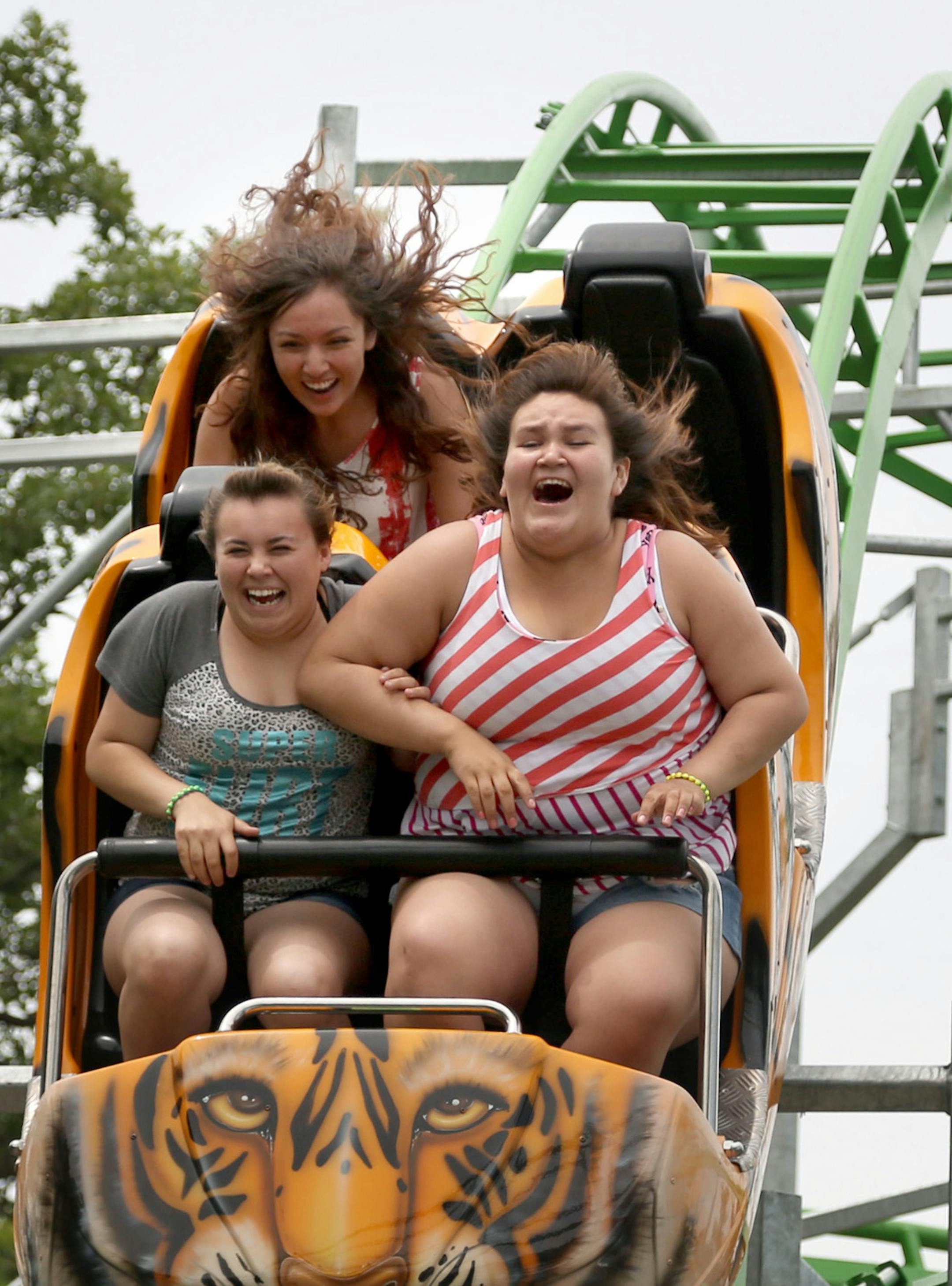 Fifteen year-olds Rickay Budreau, right, Sadie Little Wolf, and Elliana Romero in the back screamed as they went down the big hill on Tiger Trax. ] (KYNDELL HARKNESS/STAR TRIBUNE) kyndell.harkness@startribune.com At the new ride Tiger Trax at Como Town in St. Paul , Min., Tuesday, June 16, 2015. ORG XMIT: MIN1506161535580519
