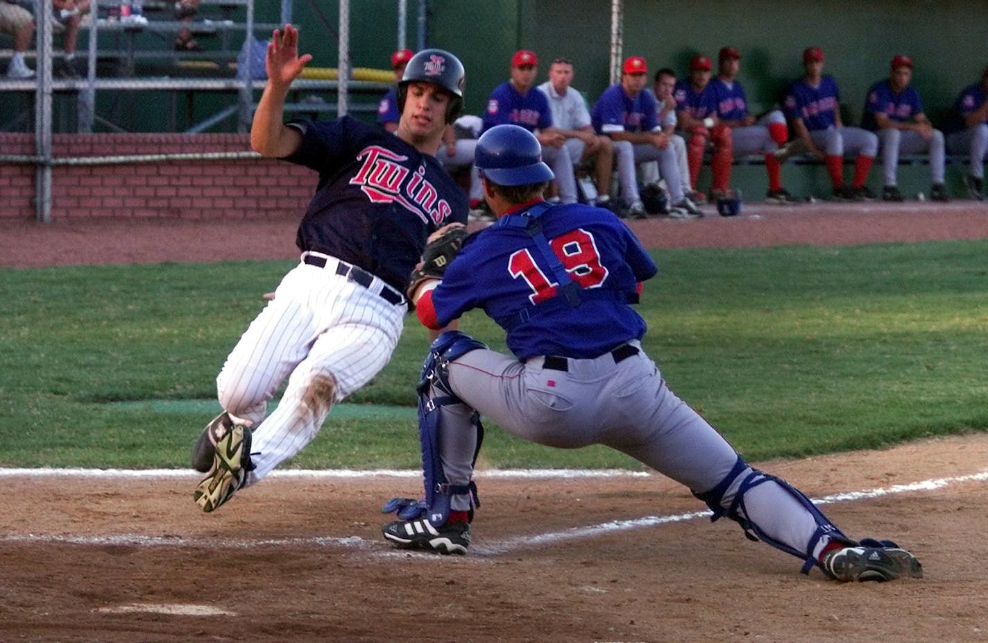 Minnesota Twins first round draft choice Joe Mauer, is tagged out at home in the 3rd inning after a base hit on his first official at bat. Mauer walked on his firsts at bat and made to third base but did not score on force out at home. Joe Mauer, made his pro debut on Monday as a DH for the E'Town Twins in Elizabethton, TN.