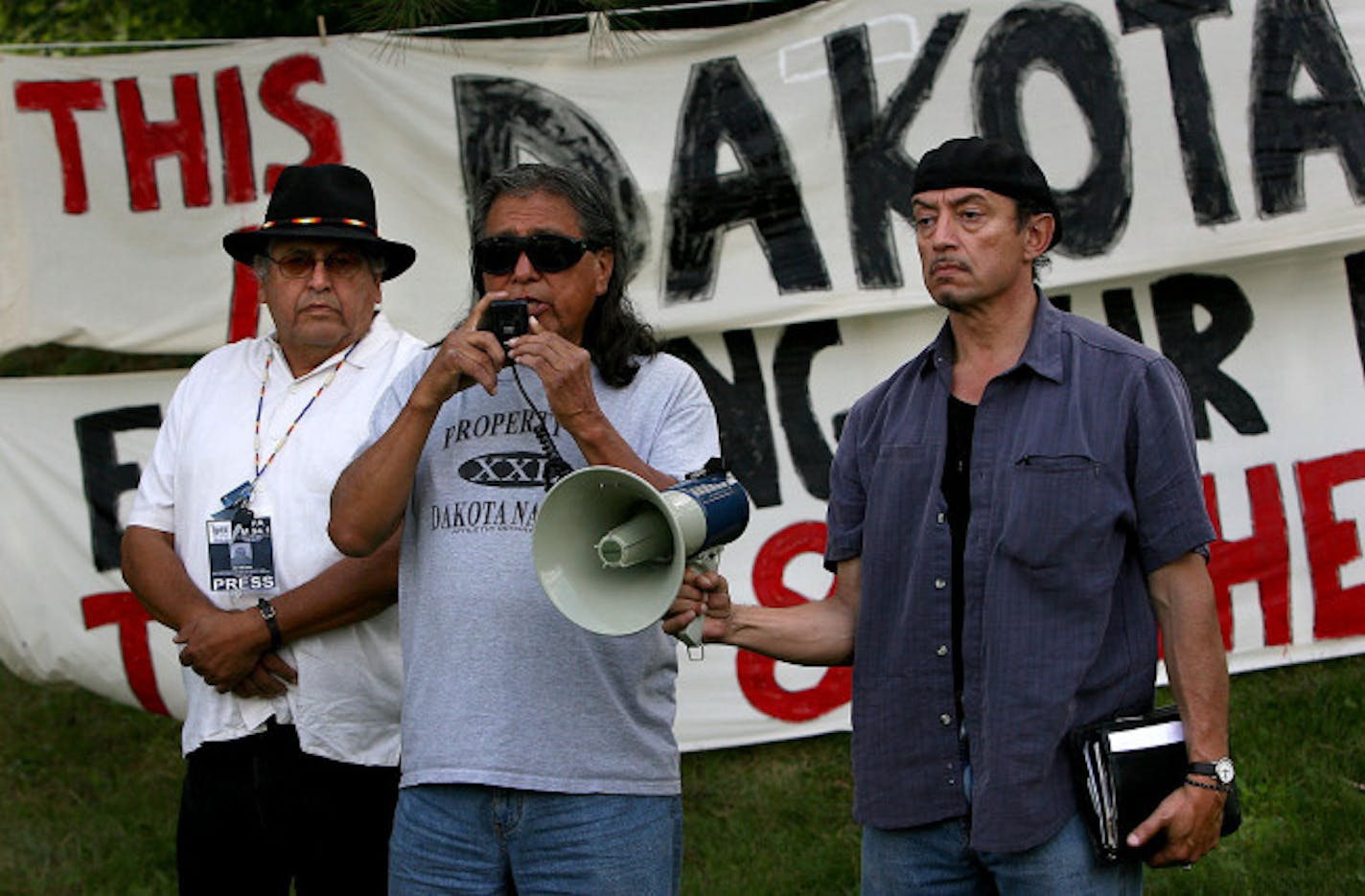 September 5, 2008 - Minneapolis MN - Bill Means, from left, Chris Mato Nunpa, and Miguel Gavilan Molina, representing the Oceti Sakowin of the Dakota Oyate gave their account to the re-occupation of the Coldwater Spring grounds during a press conference on the site of the abandoned property of the defunct Bureau of Mines.