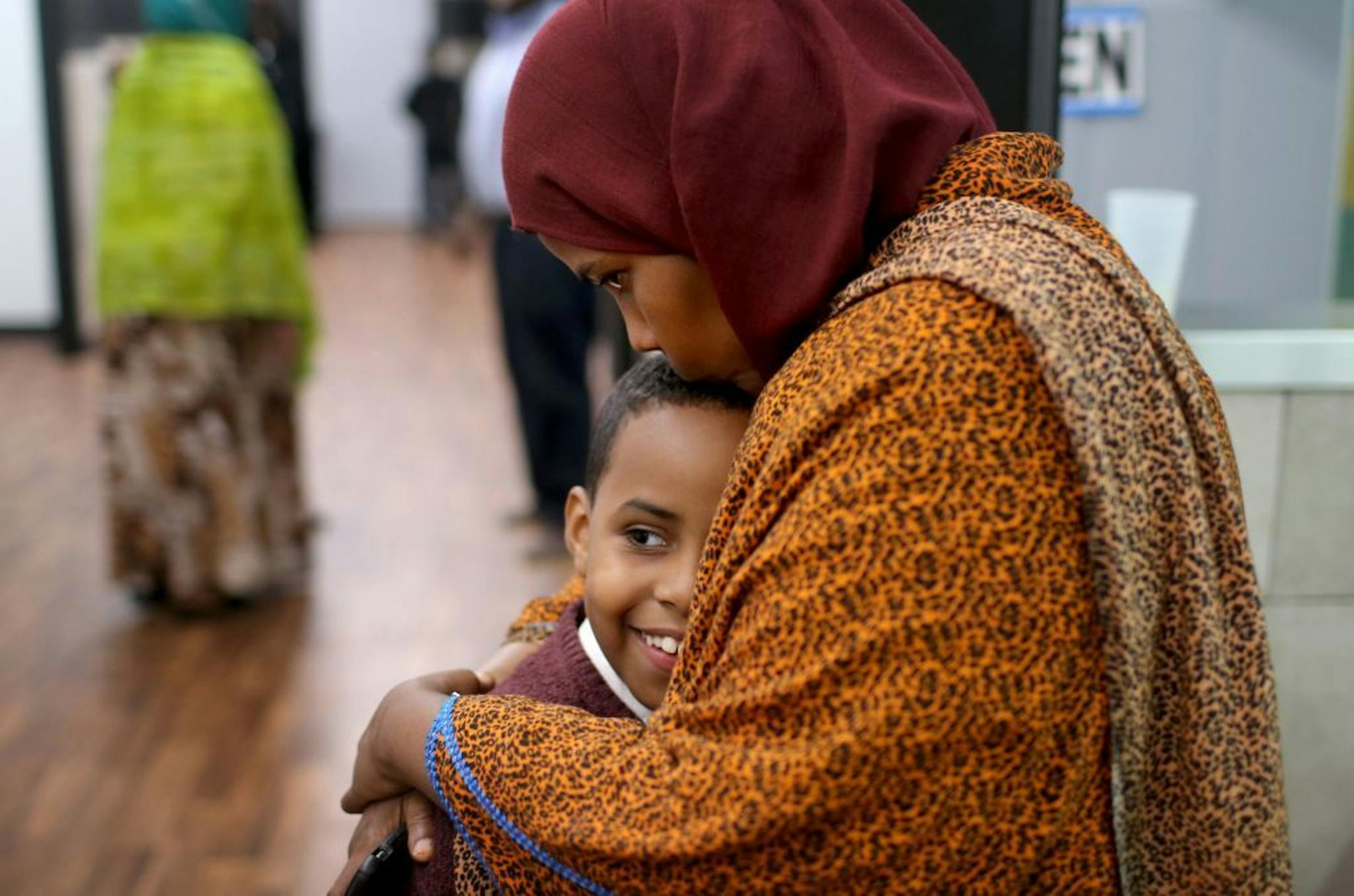 Ayan Farah, the mother of defendant Mohamed Farah, 22, hugged her youngest son Abdirahmin, 9, outside the family's restaurant Friday after Mohamed Farah and two others were convicted in federal court.
