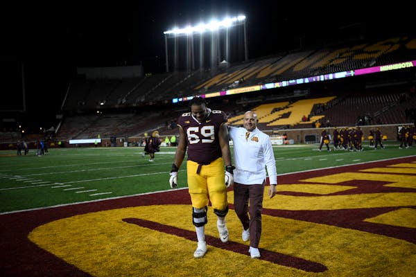 Gophers coach P.J. Fleck walked off the field with offensive lineman Aireontae Ersery after defeating Northwestern 31-3 last Nov. 12 at Huntington Ban