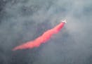 An aircraft dropped red fire retardant onto the Greenwood Fire on Tuesday, August 17, 2021 as seen from an airplane above the temporary flight restric