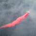 An aircraft dropped red fire retardant onto the Greenwood Fire on Tuesday, August 17, 2021 as seen from an airplane above the temporary flight restric