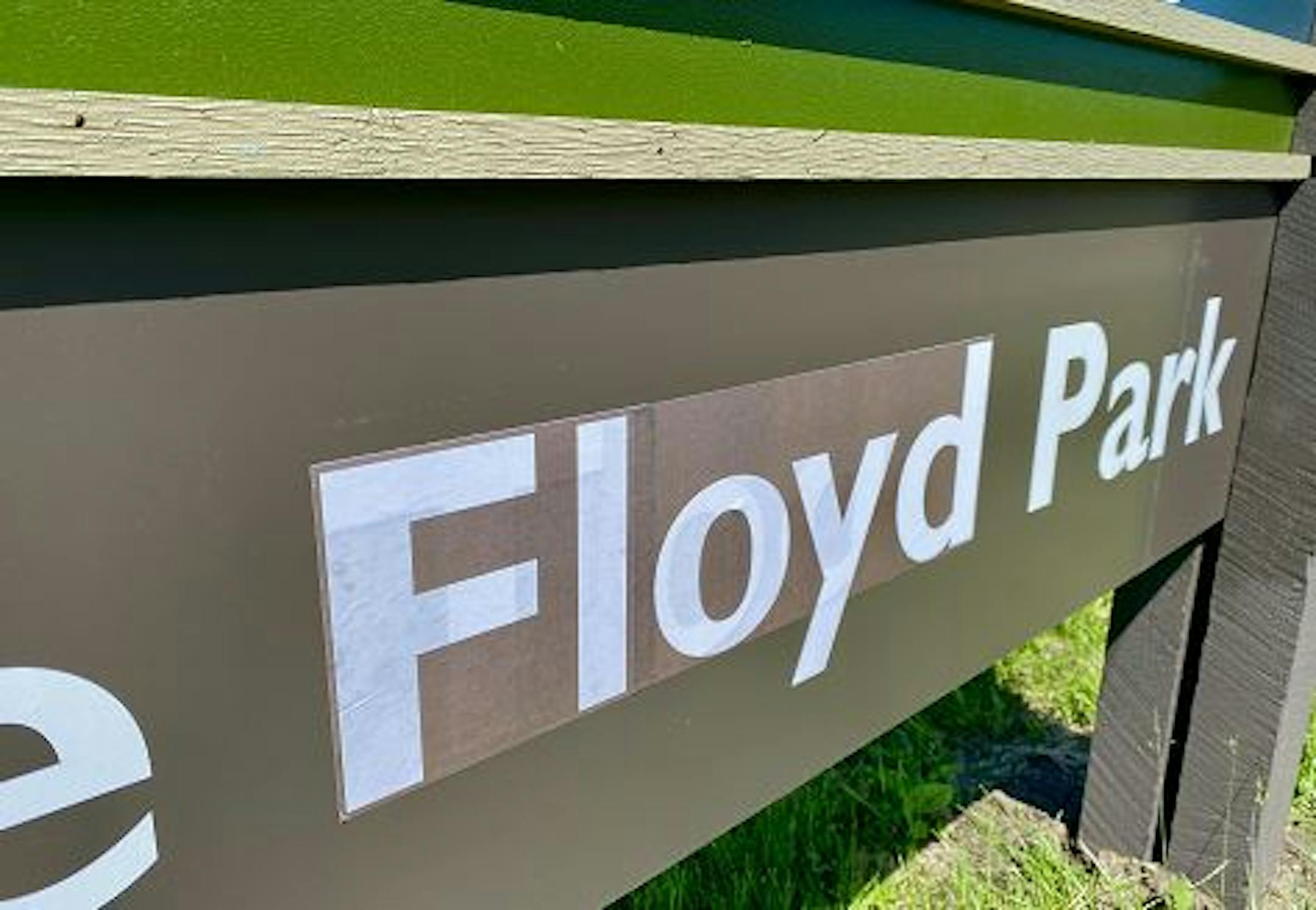 The sign had read George Todd Park until recently. The covered-over name remains faintly visible.