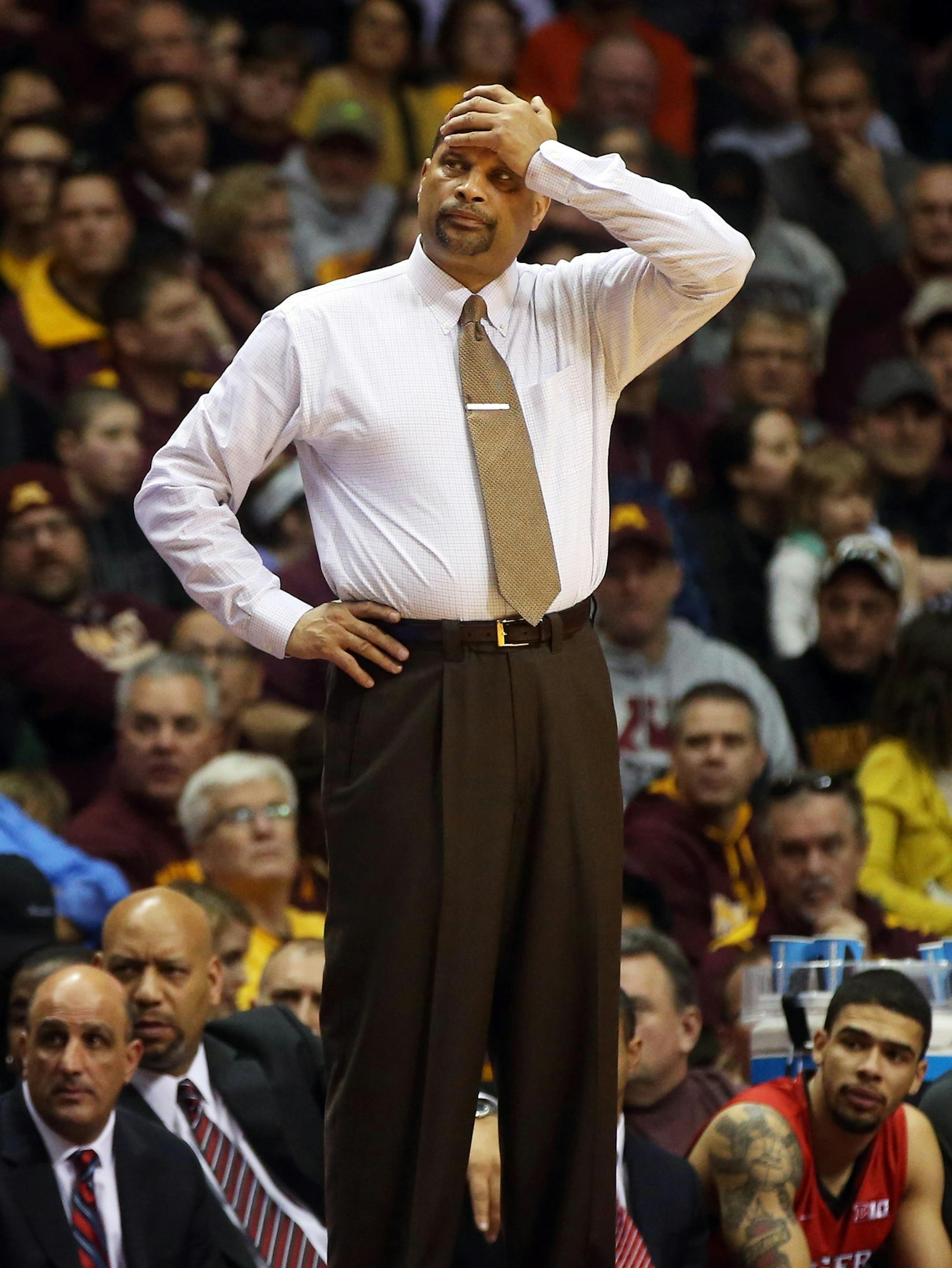 Rutgers head coach Eddie Jordan holds his head in the second half of an NCAA college basketball game against Minnesota, Saturday, Jan. 17, 2015, in Minneapolis. Minnesota won 89-80. (AP Photo/Jim Mone)