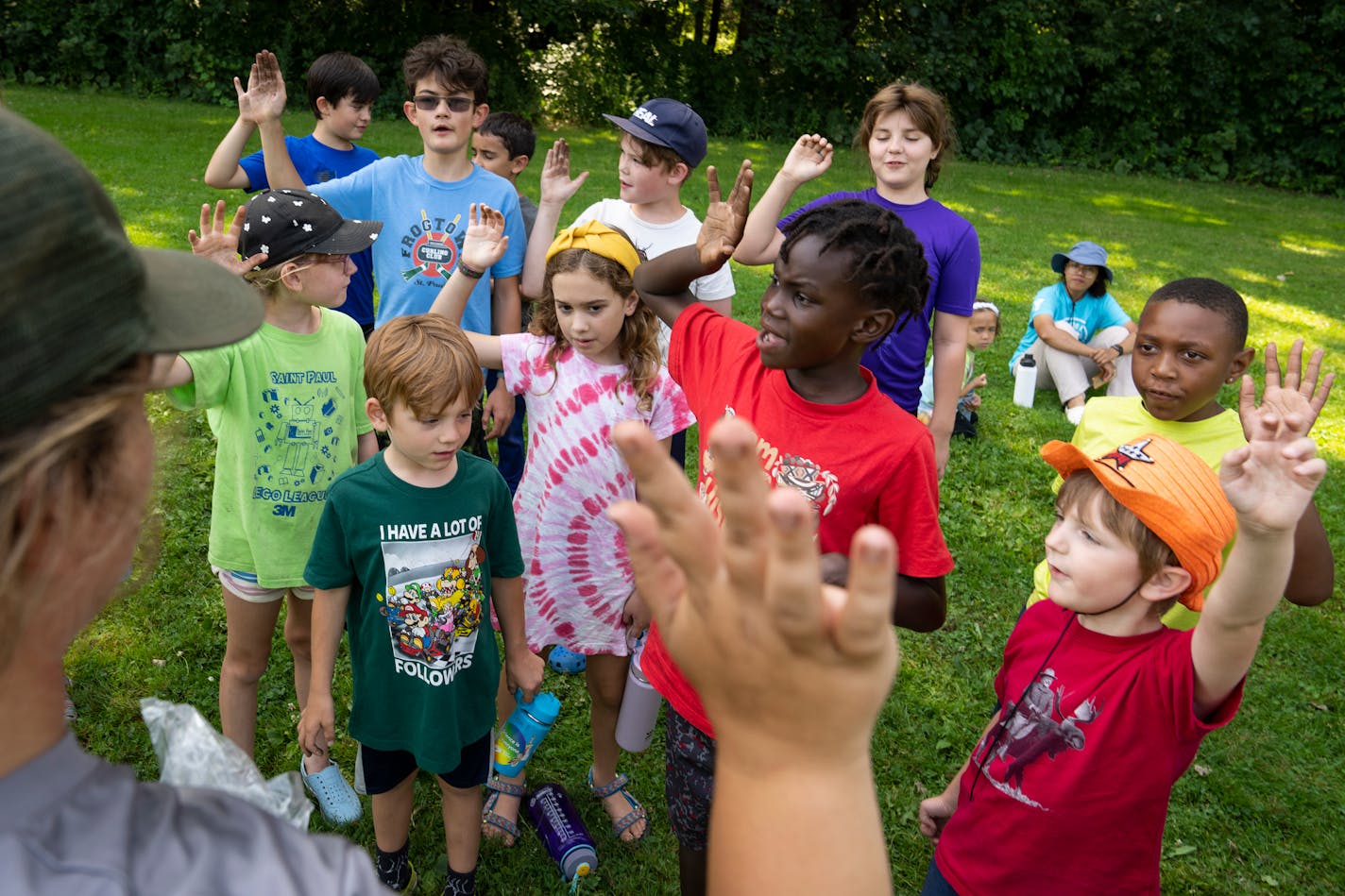 Campers took a junior ranger oath after throwing seed bombs at Crosby Farm Regional Park during YMCA Adventure in the Neighborhood day camp. From left are 8-year-olds Desiree Byrd, Harriet Bathke, Ada Beger and Elizabeth Czarniecki.