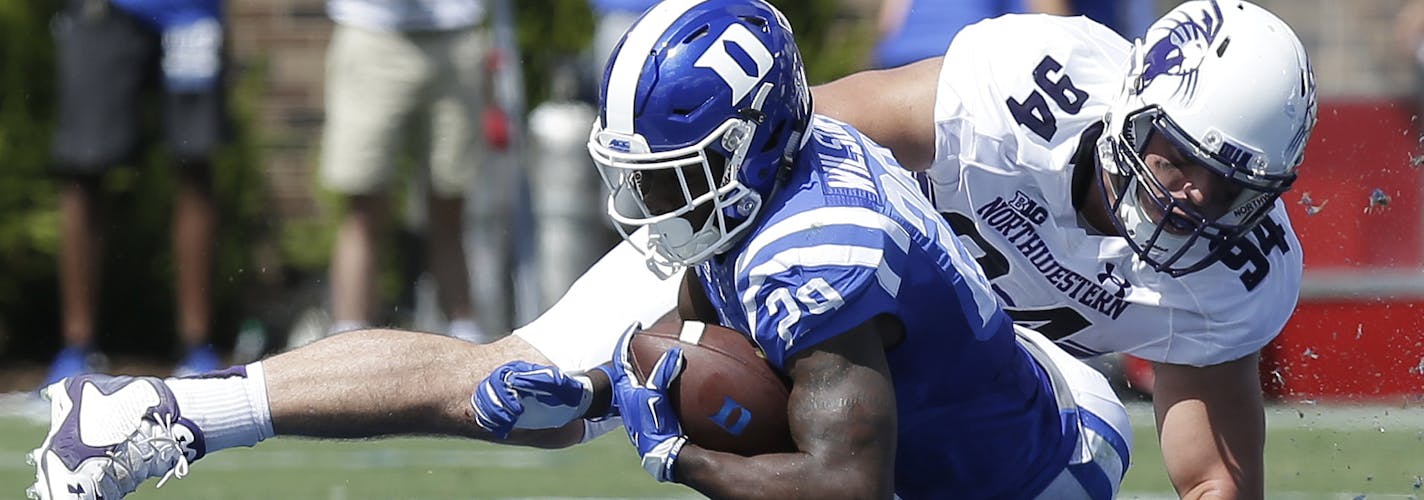 Duke's Shaun Wilson is tackled by Northwestern's Dean Lowry (94) during the first half of an NCAA college football game in Durham, N.C., Saturday, Sept. 19, 2015. (AP Photo/Gerry Broome)