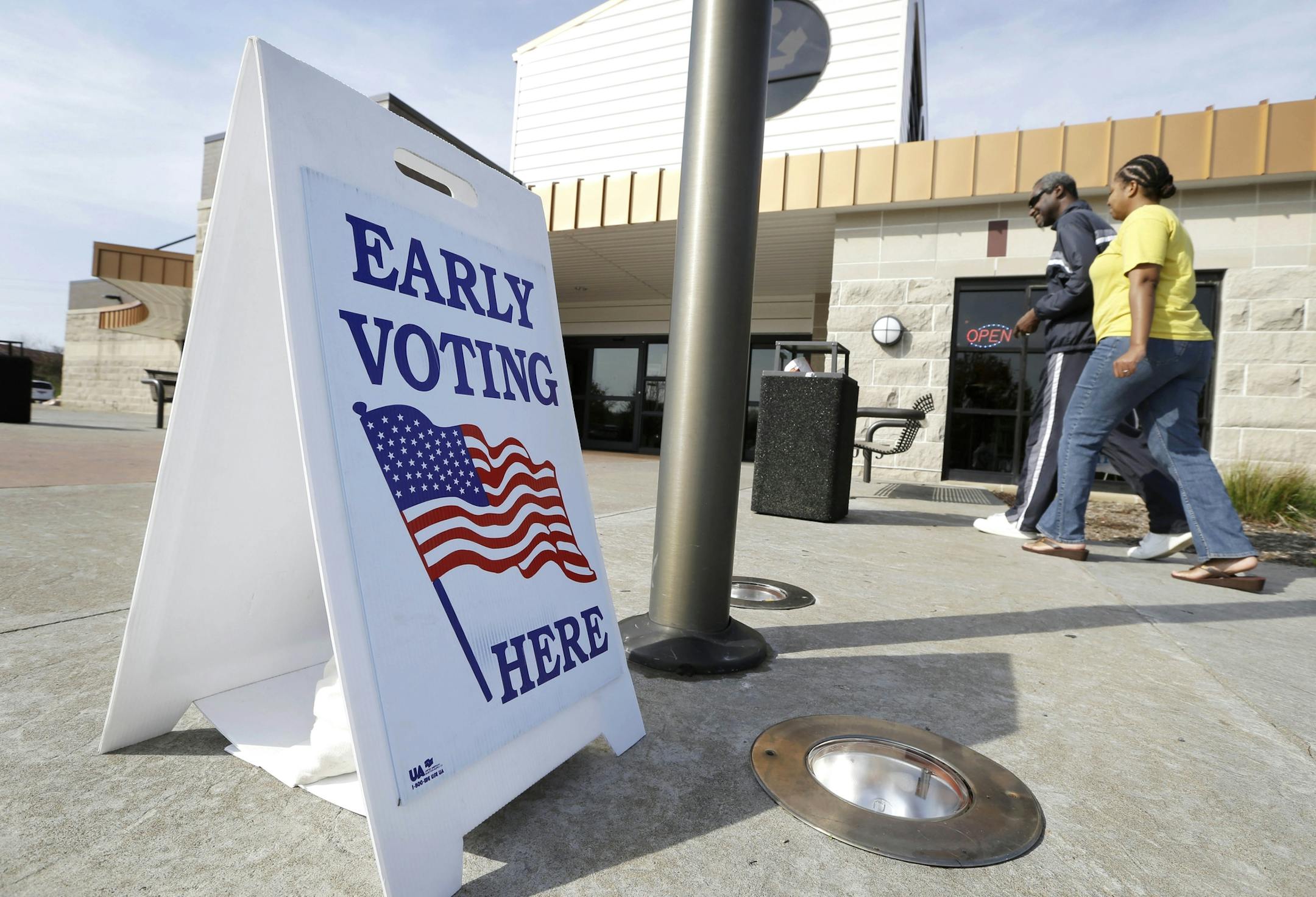 FILE - In this Oct. 24, 2012 file photo Oliver Solomon and his wife LaDonna arrive at the Davenport, Iowa, Public Library to cast their ballot early. For years, Democrats have dominated early voting in Iowa while Republicans largely focused on Election Day turnout. The GOP has invested millions in the Nov. 4, 2014 election and this time hopes to get conservatives to cast ballots early, a decision that may prove vital in a tight U.S. Senate race in Iowa. (AP Photo/Charlie Neibergall, File)