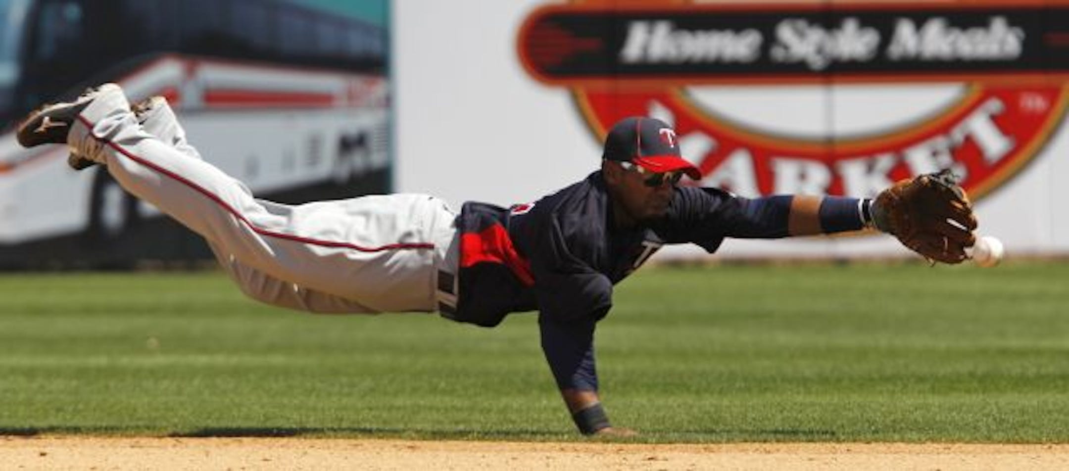 Minnesota Twins shortstop Alexi Casilla stretches out as Toronto Blue Jays' J.P. Arencibia's fifth-inning single evades his glove in the Twins' 3-0 loss to the Jays in their spring training baseball game at Florida Auto Exchange Stadium in Dunedin, Fla., Sunday, March 20, 2011.
