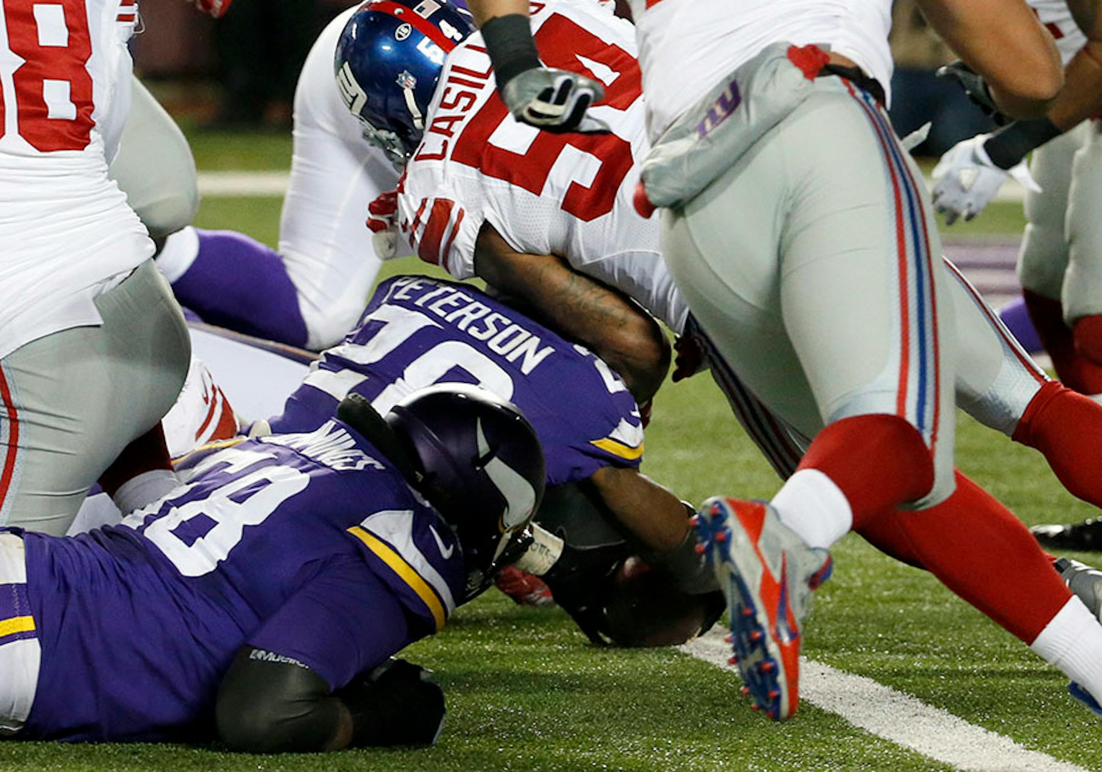 Minnesota Vikings running back Adrian Peterson (28) leans for a touchdown as he is hit by New York Giants outside linebacker Jonathan Casillas (54) during the second half of an NFL football game, Sunday, Dec. 27, 2015, in Minneapolis.