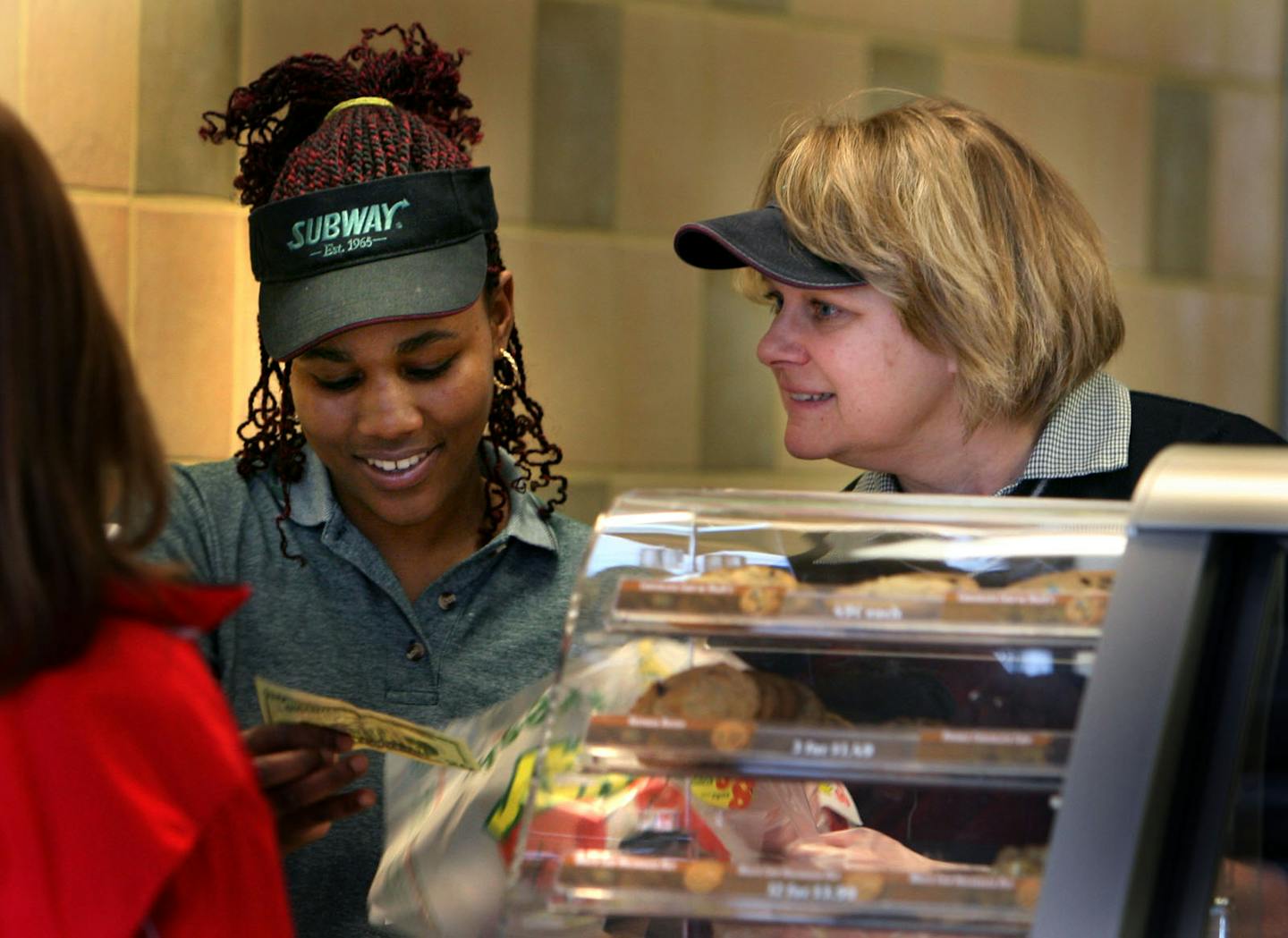 Subway employee Alexis Hancock received training from Kim Ward on a new register on opening day of a new Subway in Ham Lake.