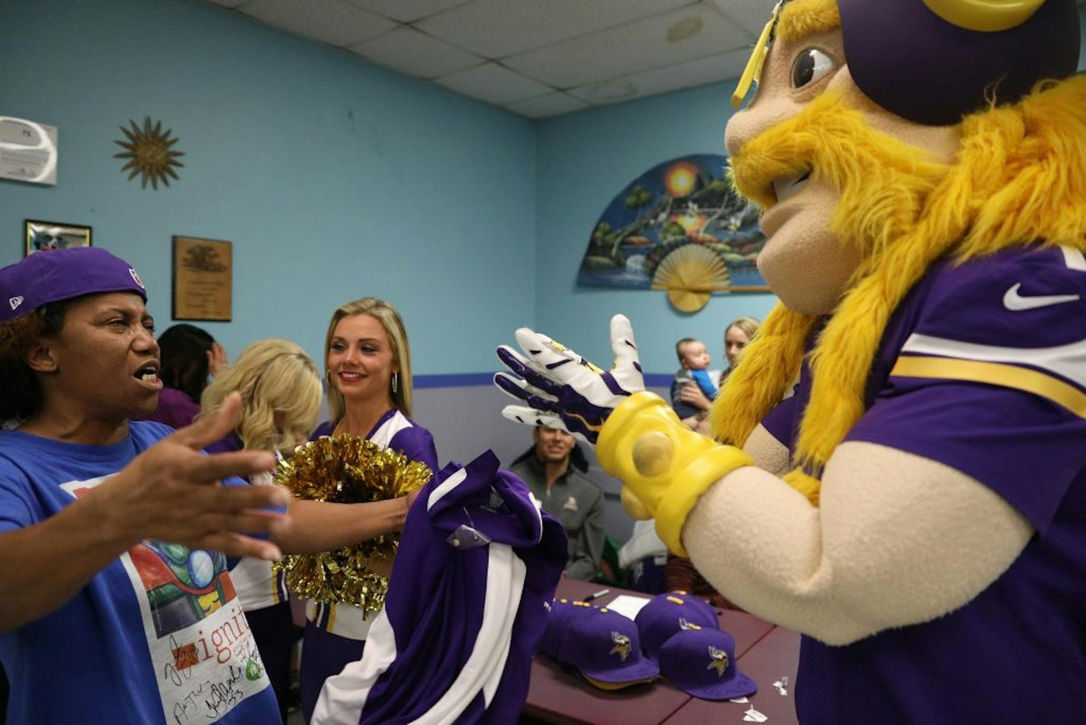 Viktor the Viking got a hug from Tracey Woods after he gave her an autographed hat and jacket during a raffle Tuesday.