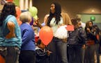 MPS mom Tracine Asberry, who is also a MInneapolis School Board member, chats while her son Miles Asberry-Wallace, 2, plays with a balloon Saturday, J