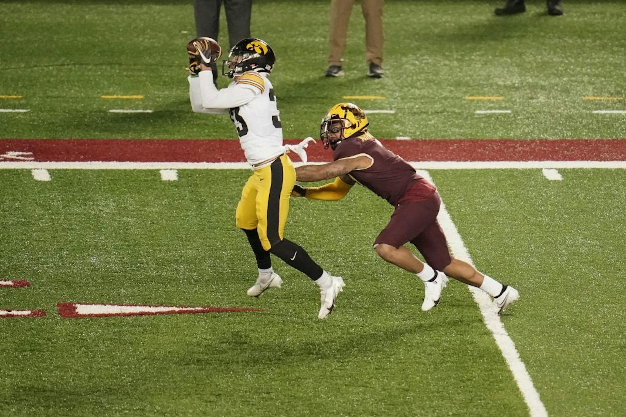 Iowa Hawkeyes defensive back Riley Moss (33) intercepted a pass intended for Minnesota Gophers wide receiver Chris Autman-Bell (7) in the fourth quarter.