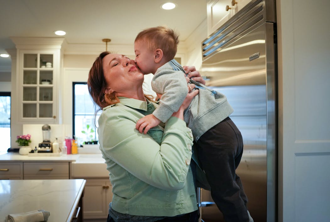 Ries gives her son Heathcliff Reimers a goodbye hug and kiss before departing for the KSTP studio. A highly visible working mom, Ries often speaks about the challenges of balancing family and career.
