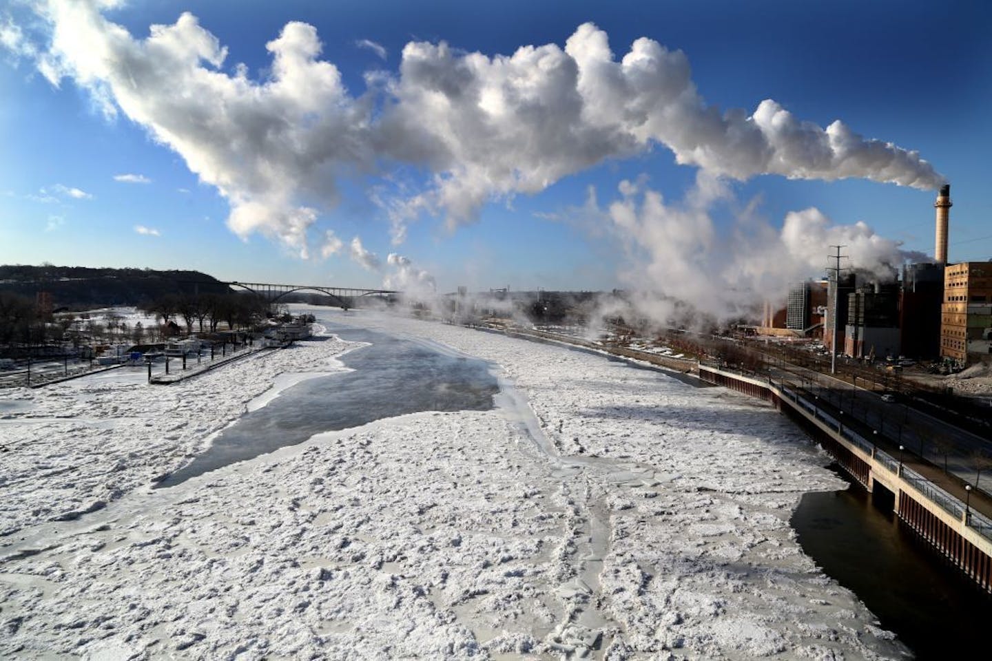 Seen from the Wabasha Street Bridge, most of the Mississippi River is frozen below as arctic air settles in Wednesday, Jan. 4, 2016, in St. Paul, MN.