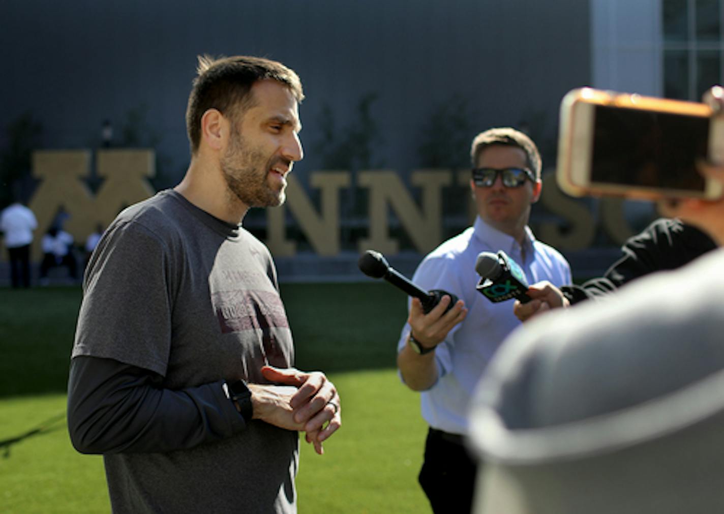 University of Minnesota defensive coordinator Joe Rossi being interviewed by media members following practice Wednesday, Oct. 9, 2019, in Minneapolis, MN.]