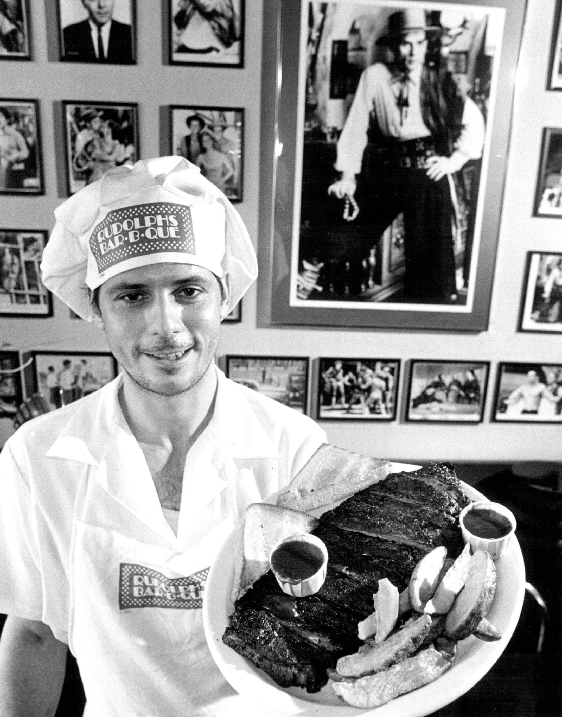 September 4, 1985 Bar-B-Que Rudolph's kitchen manager Kenny Frazee displayed a "Humphrey Bogart" special in one of the dining rooms with walls covered with photos that's Rudolph Nureyev as valentine in large photo Charles Bjorgen, Minneapolis Star Tribune