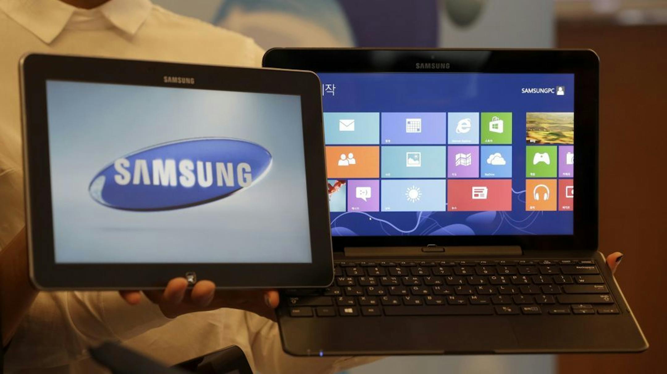 Samsung Electronics Co's ATIV smart PC and tablet, powered by a new version of Microsoft's Windows operating system, are shown at a media briefing in Seoul, South Korea, Wednesday, Oct. 24, 2012.