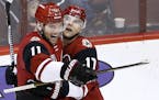 Arizona Coyotes center Martin Hanzal (11) smiles as he celebrates his game-winning goal against the San Jose Sharks with right wing Radim Vrbata (17) 
