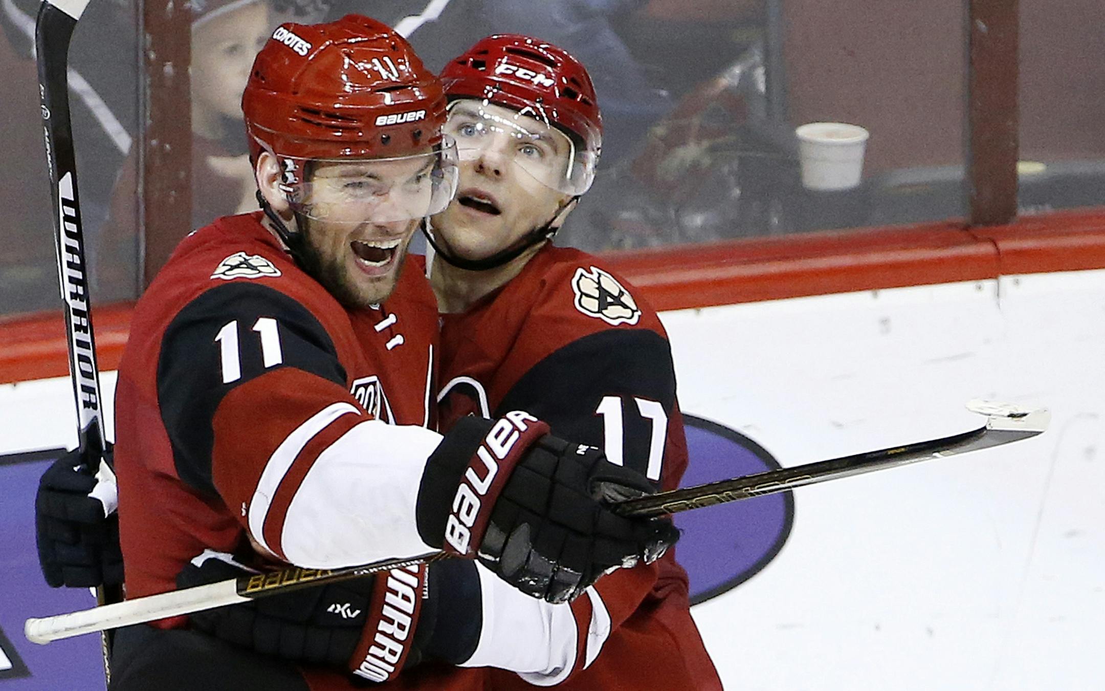 Arizona Coyotes center Martin Hanzal (11) smiles as he celebrates his game-winning goal against the San Jose Sharks with right wing Radim Vrbata (17) during overtime of an NHL hockey game Saturday, Nov. 19, 2016, in Glendale, Ariz. The Coyotes defeated the Sharks 3-2. (AP Photo/Ross D. Franklin) ORG XMIT: PNJ110