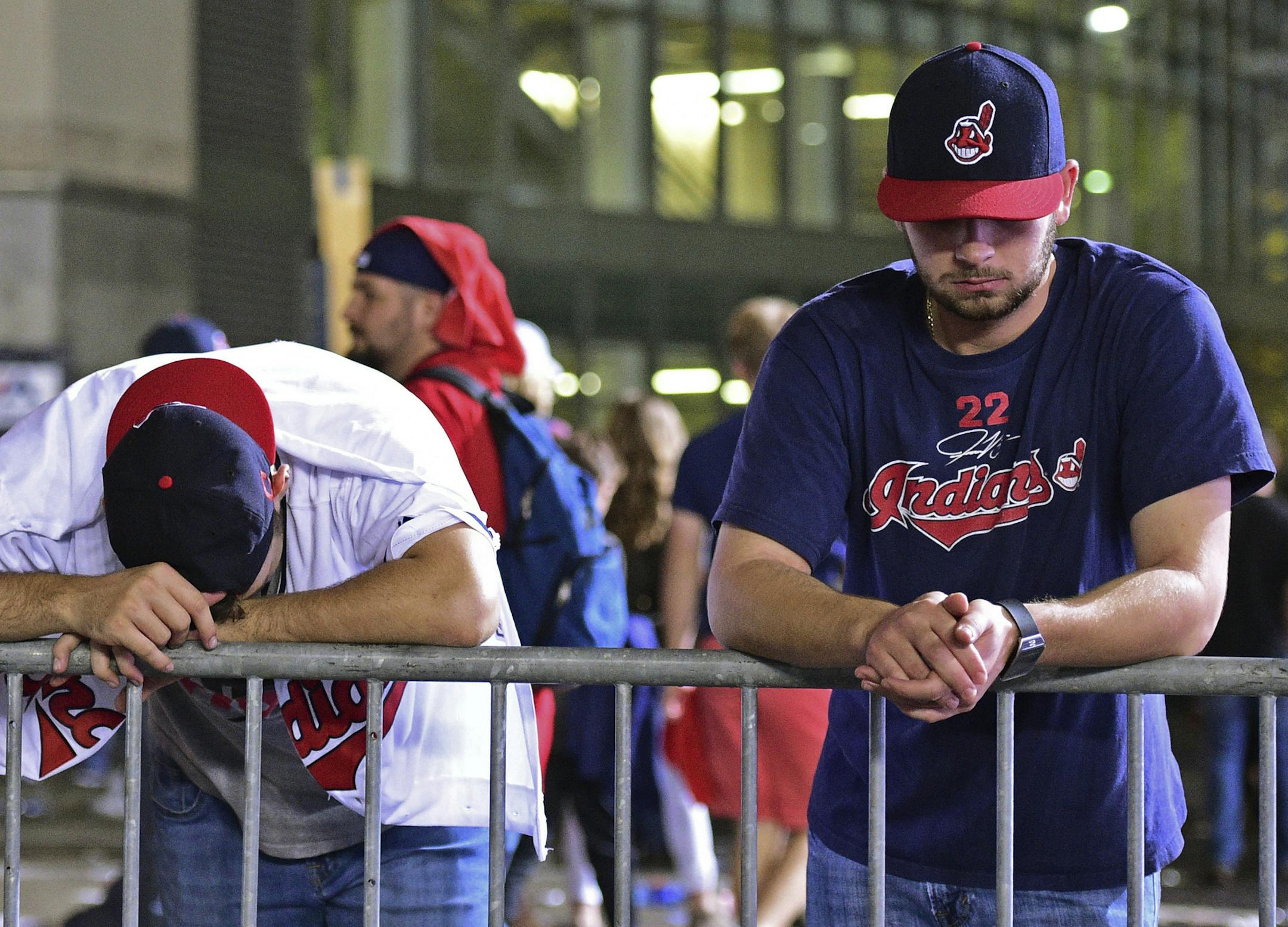 Cleveland Indians fans Levi Jones, left, and Kyle Zabarsky react during a watch party, after Game 7 of the baseball World Series between the Indians and the Chicago Cubs, outside Progressive Field, early Thursday, Nov. 3, 2016, in Cleveland. The Cubs won 8-7 to win the series. (AP Photo/David Dermer)
