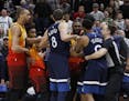 Minnesota Timberwolves' Jeff Teague (0) and Utah Jazz's Jae Crowder, back, tussle after Teague was called for a foul for pushing Utah Jazz's Ricky Rub