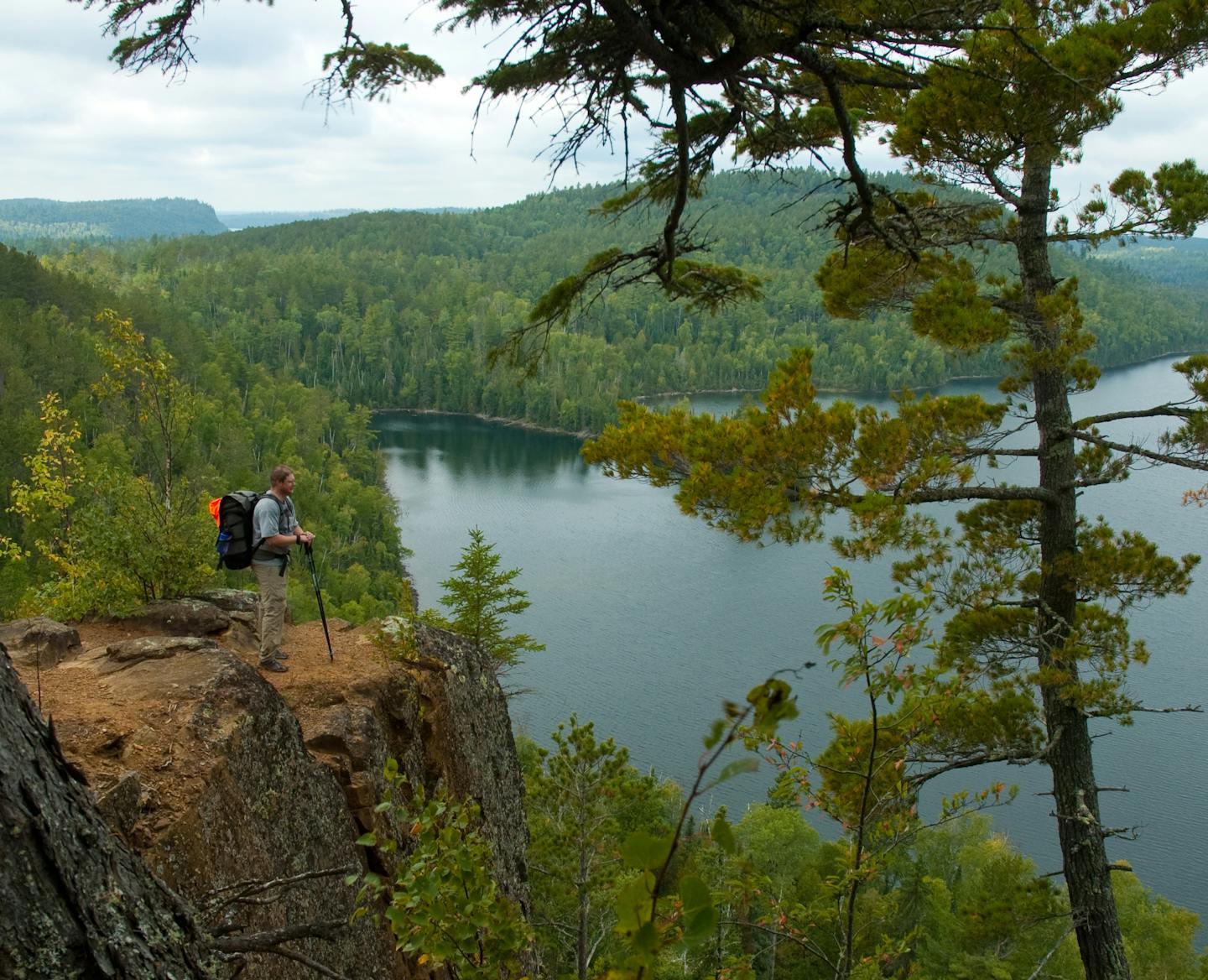 - Hiker takes in a view from the Rose Lake cliffs along the Border Route Trail in the BWCAW,