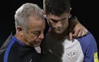 United States' Christian Pulisic, (10) is comforted after losing 2-1 against Trinidad and Tobago during a 2018 World Cup qualifying soccer match &#x20