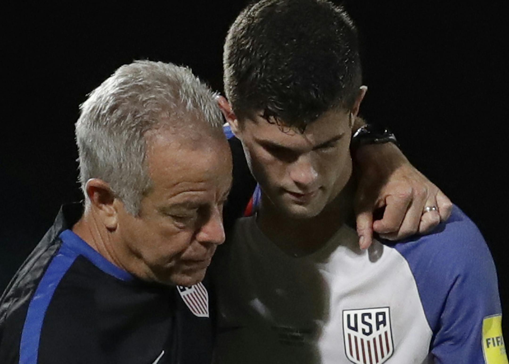 United States' Christian Pulisic, (10) is comforted after losing 2-1 against Trinidad and Tobago during a 2018 World Cup qualifying soccer match &#x2020;in Couva, Trinidad, Tuesday, Oct. 10, 2017. (AP Photo/Rebecca Blackwell)