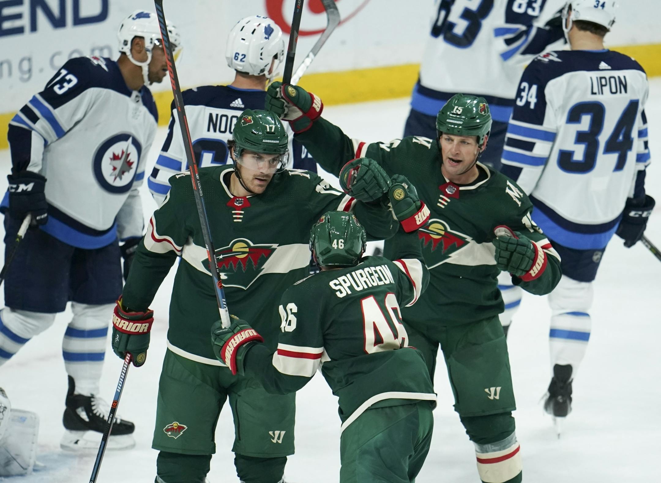 Minnesota Wild left wing Marcus Foligno (17) and Wild center Matt Hendricks (15) were first to congratulate defenseman Jared Spurgeon (46) on what proved to be the game winning goal in the third period Wednesday night.