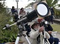 A man takes pictures of a total solar eclipse in Chascomus, Argentina, Tuesday, July 2, 2019. A solar eclipse occurs when the moon passes between the 