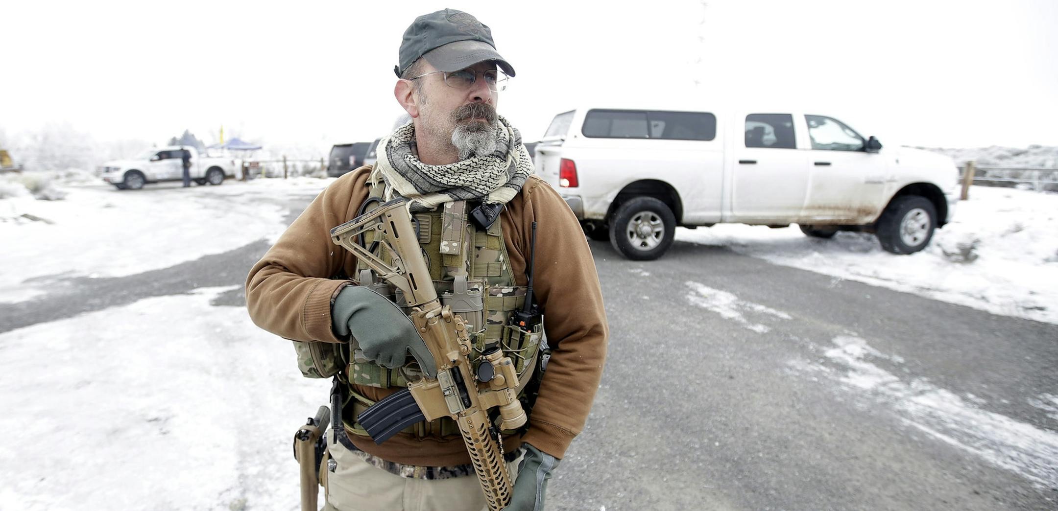A man stands guard after members of the "3% of Idaho" group along with several other organizations arrived at the Malheur National Wildlife Refuge near Burns, Ore., on Saturday, Jan. 9, 2016. A small, armed group has been occupying the remote national wildlife refuge in Oregon for a week to protest federal land use policies. (AP Photo/Rick Bowmer) ORG XMIT: MIN2016010918522748