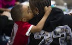 Jeriko Dejvaun Boykin Jr., 4, kissed his grandmother Catherine Harris at a listening session Tuesday about the violence in St. Paul. Jeriko Jr. was in
