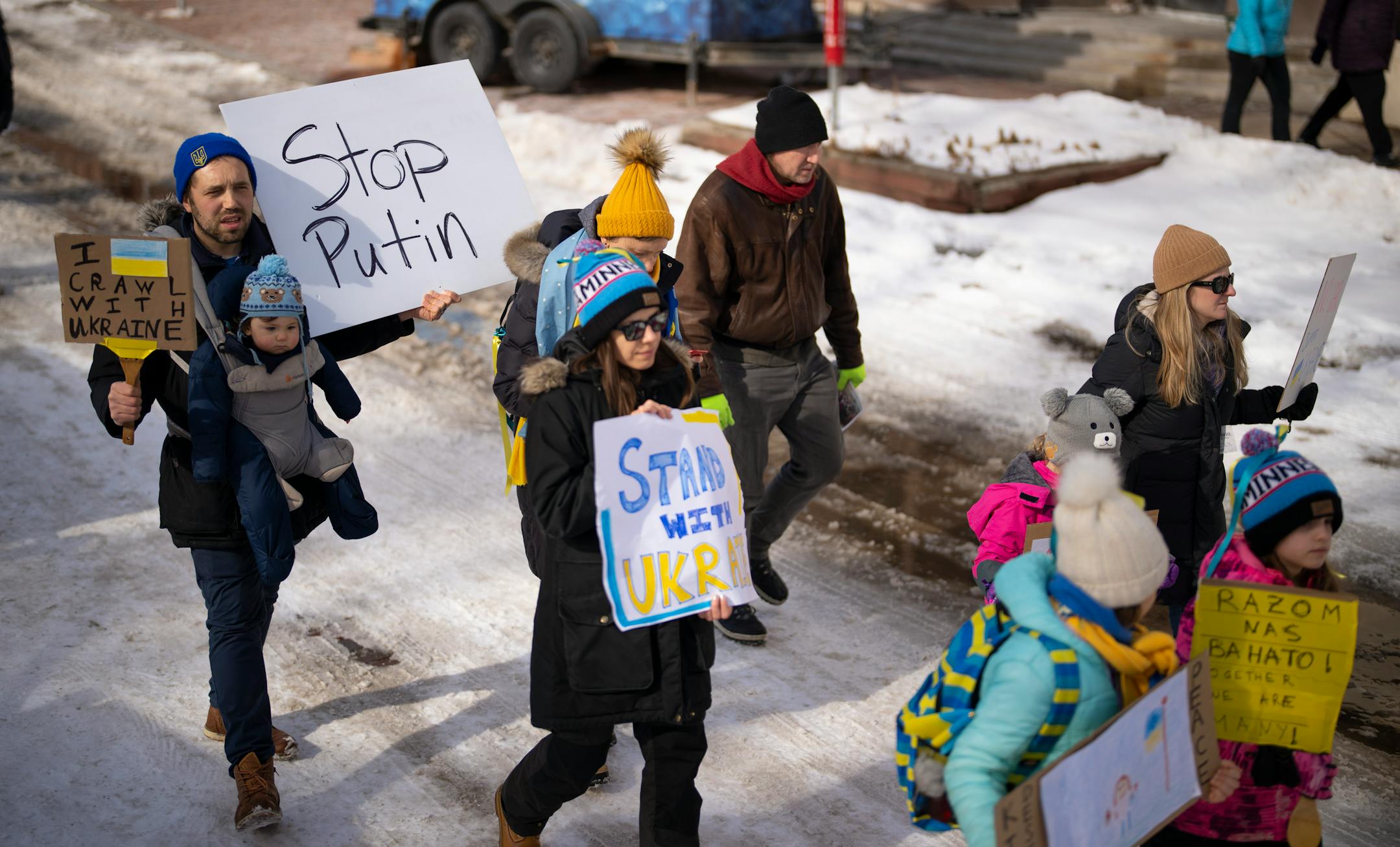 Marchers showing support for Ukraine walked on Main St. SE towards the Stone Arch Bridge Sunday afternoon, February 27, 2022 in Minneapolis, Minn. Hundreds of supporters of the people of Ukraine met a few dozen supporters of the Belarusian people midway across the Stone Arch Bridge in Minneapolis before continuing on a march together across the Hennepin Ave. bridge to Northeast Minneapolis where the march first began. ] JEFF WHEELER • Jeff.Wheeler@startribune.com