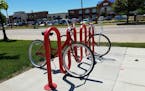 In Austin, Minn's. bike-sharing program, volunteers refurbish donated bikes, which are painted bright red and put into matching bike racks for anyone 