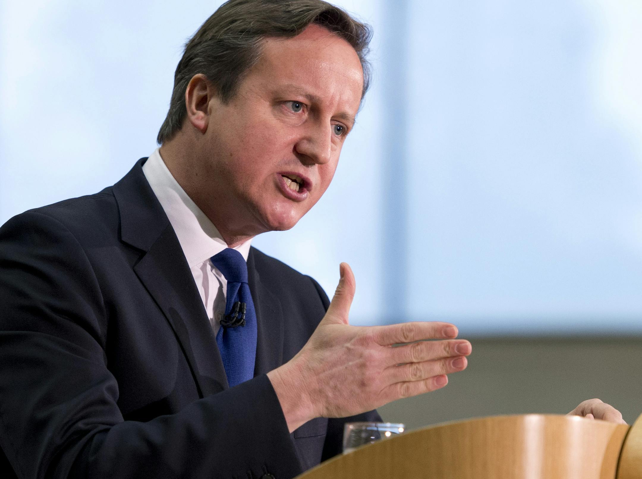 British Prime Minister David Cameron gestures as he delivers a speech on immigration to factory workers and members of the media, at JCB World Headquarters in Rocester, central England, Friday, Nov. 28, 2014. Migrants from Europe will have to leave Britain if they don't get a job within six months, and must work for four years before receiving some benefits, Prime Minister David Cameron announced Friday, in a carefully balanced speech designed to defuse domestic criticism of his immigration poli