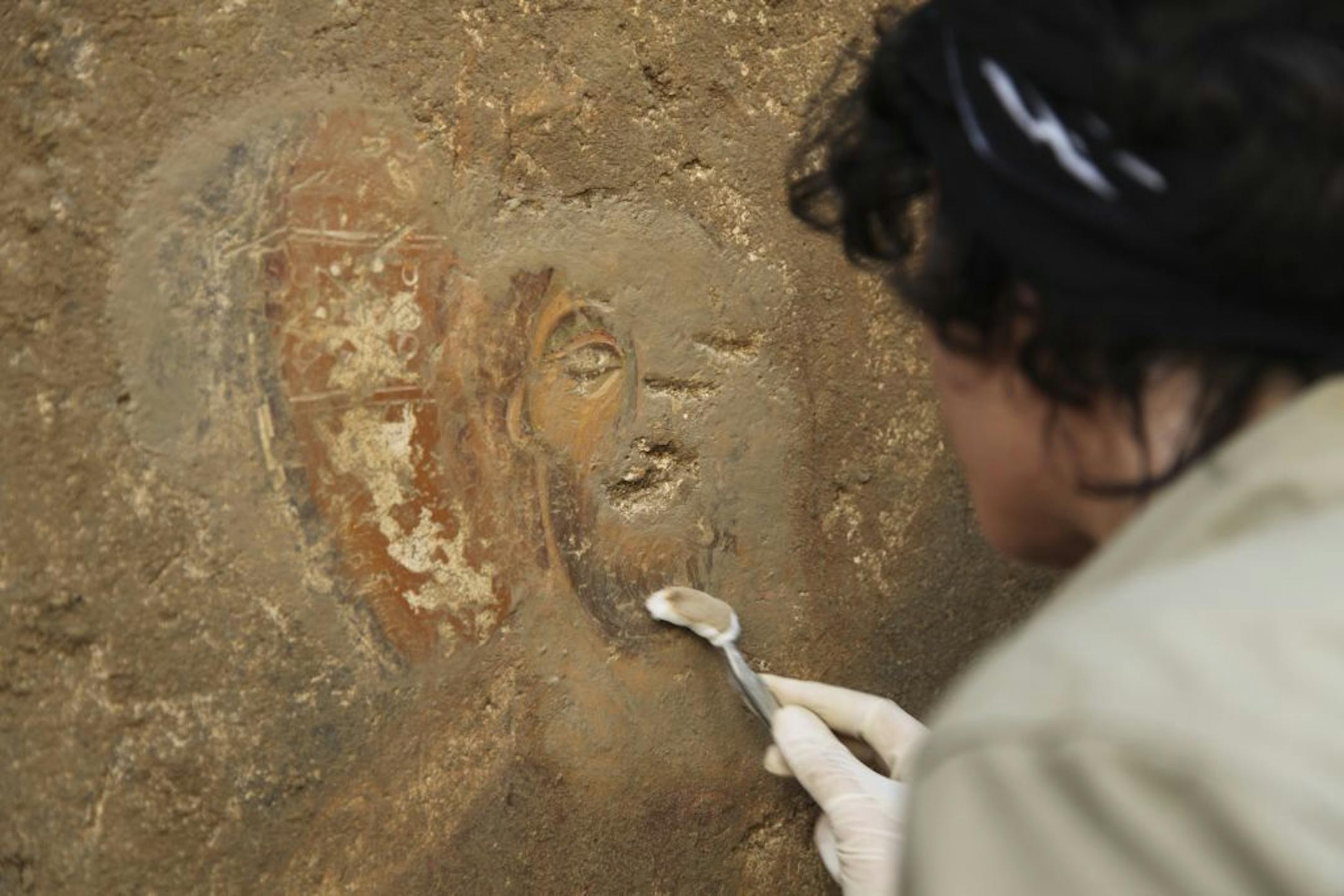 In an undated handout photo, a restorer cleans a preserved deesis fresco that appears under alluvium at an excavation site in Turkey. The excellent condition of a newly discovered 13th-century chapel has stirred hopes among archaeologists that an entire city may be largely intact underground. (Myra-Andriake Excavations via The New York Times) -- NO SALES; FOR EDITORIAL USE ONLY WITH STORY SLUGGED SCI TURKEY EXCAVATION BY JENNIFER PINKOWSKI. ALL OTHER USE PROHIBITED.