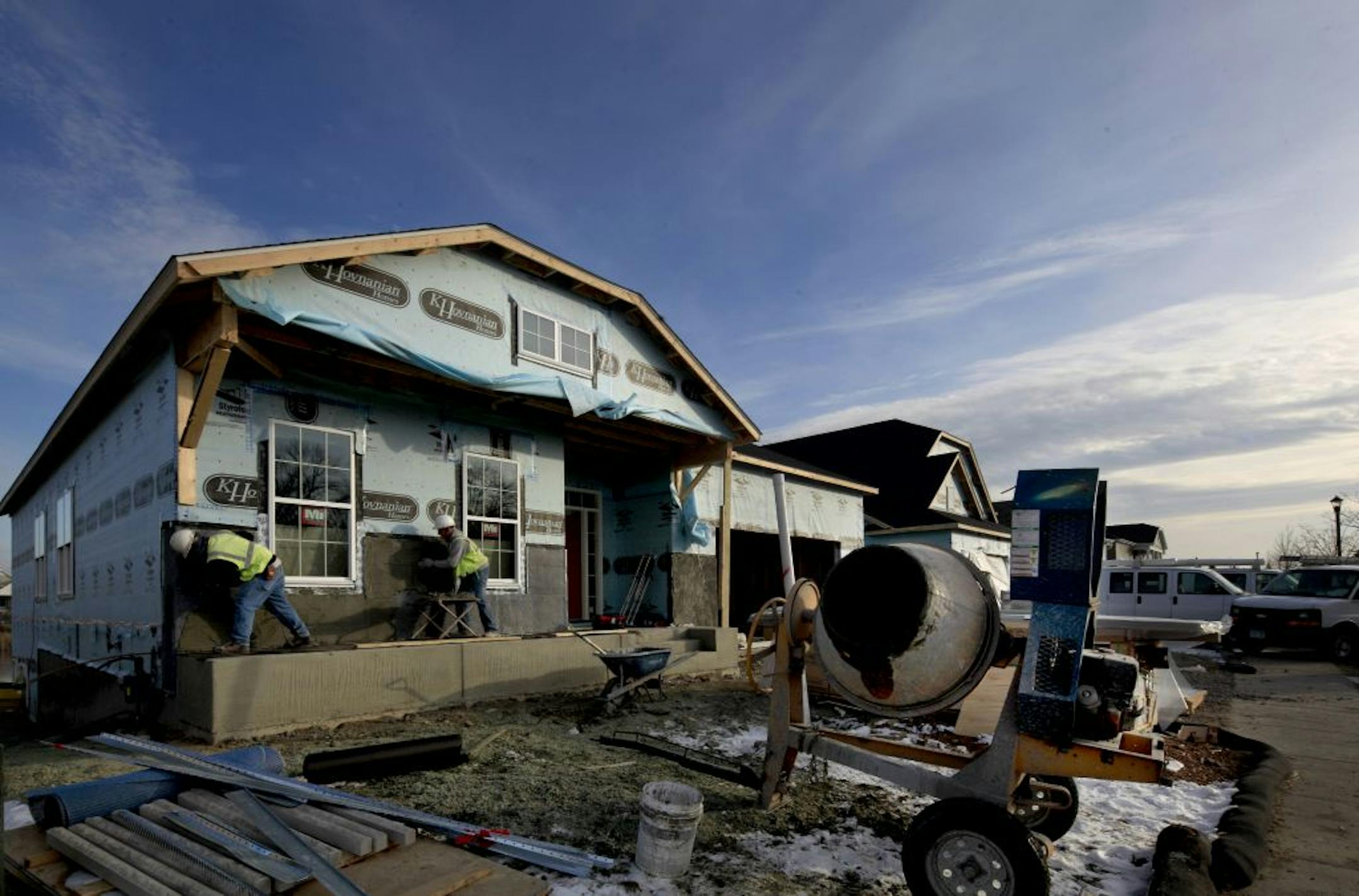 Matt Jones, left, and Mike Engle of Manor Concrete prepped a home for stonework Wednesday at Four Seasons at Rush Creek in Maple Grove.