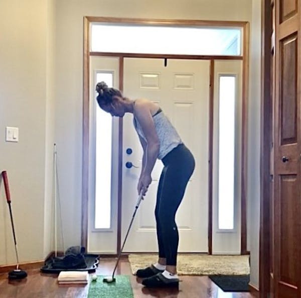 Amy Olson, LPGA golfer from Fargo, working on her putting in her front hallway in Fargo.