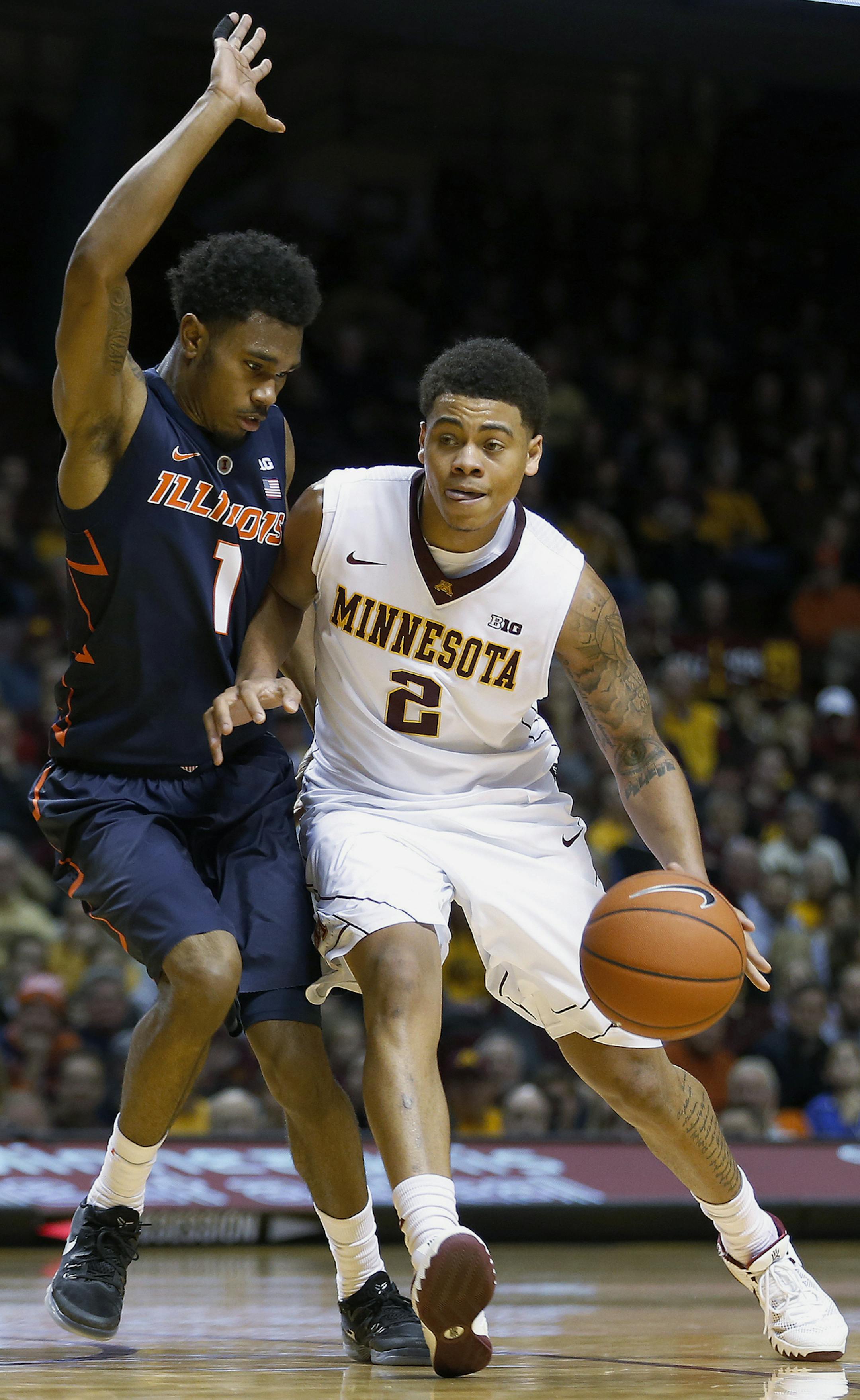 Minnesota guard Nate Mason (2) drives the ball down court against Illinois guard Jaylon Tate (1) in the second half of an NCAA college basketball game Saturday, Jan. 23, 2016 in Minneapolis. (AP Photo/Stacy Bengs)