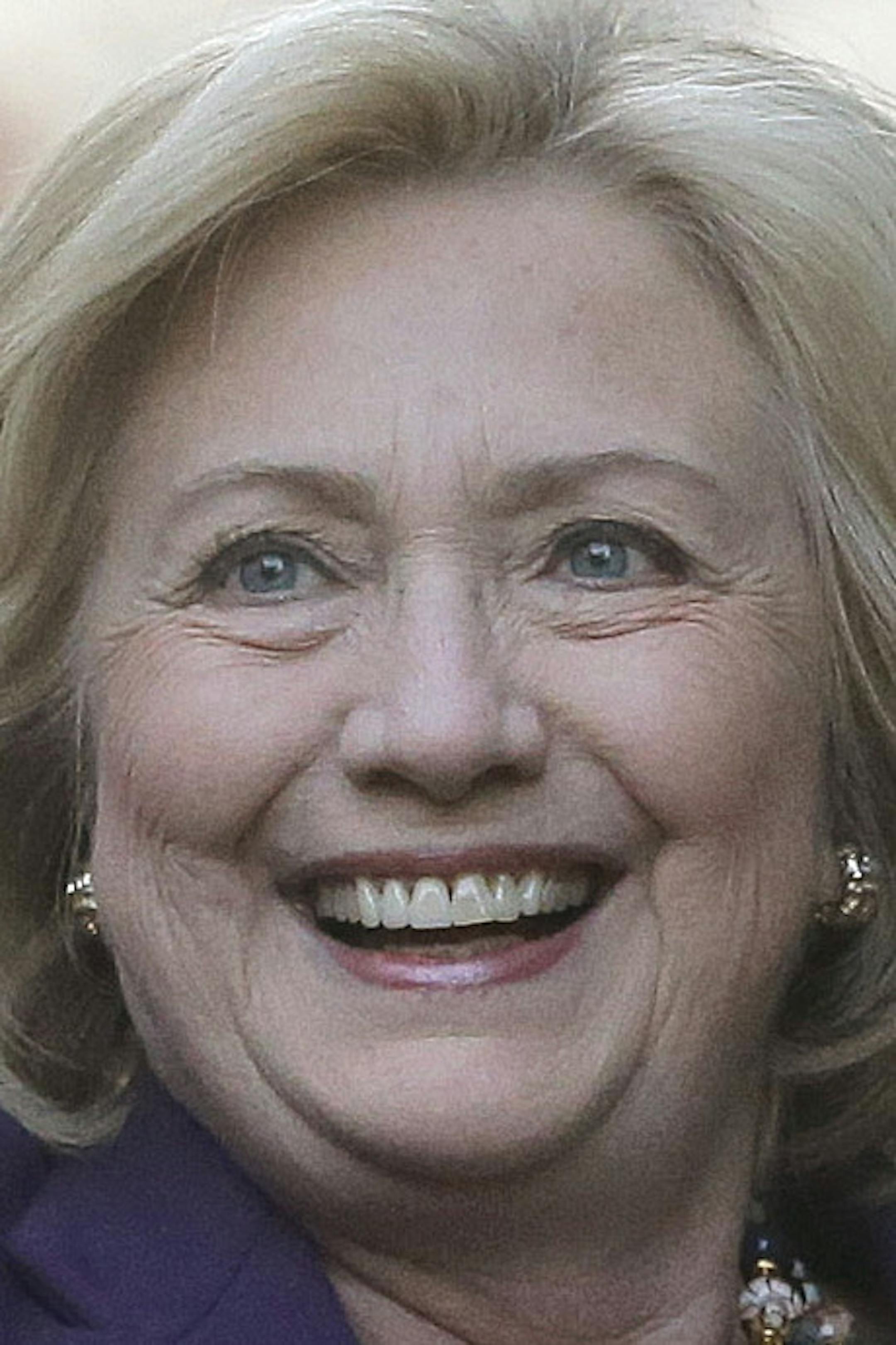Democratic presidential candidate Hillary Clinton, right, waves to people in a crowd before a rally at Faneuil Hall, Sunday, Nov. 29, 2015, in Boston. Clinton and Boston Mayor Marty Walsh attended the event held to launch “Hard Hats for Hillary," a coalition to organize working families in construction, building, transportation, and other labor industries to support Clinton's agenda. (AP Photo/Steven Senne)