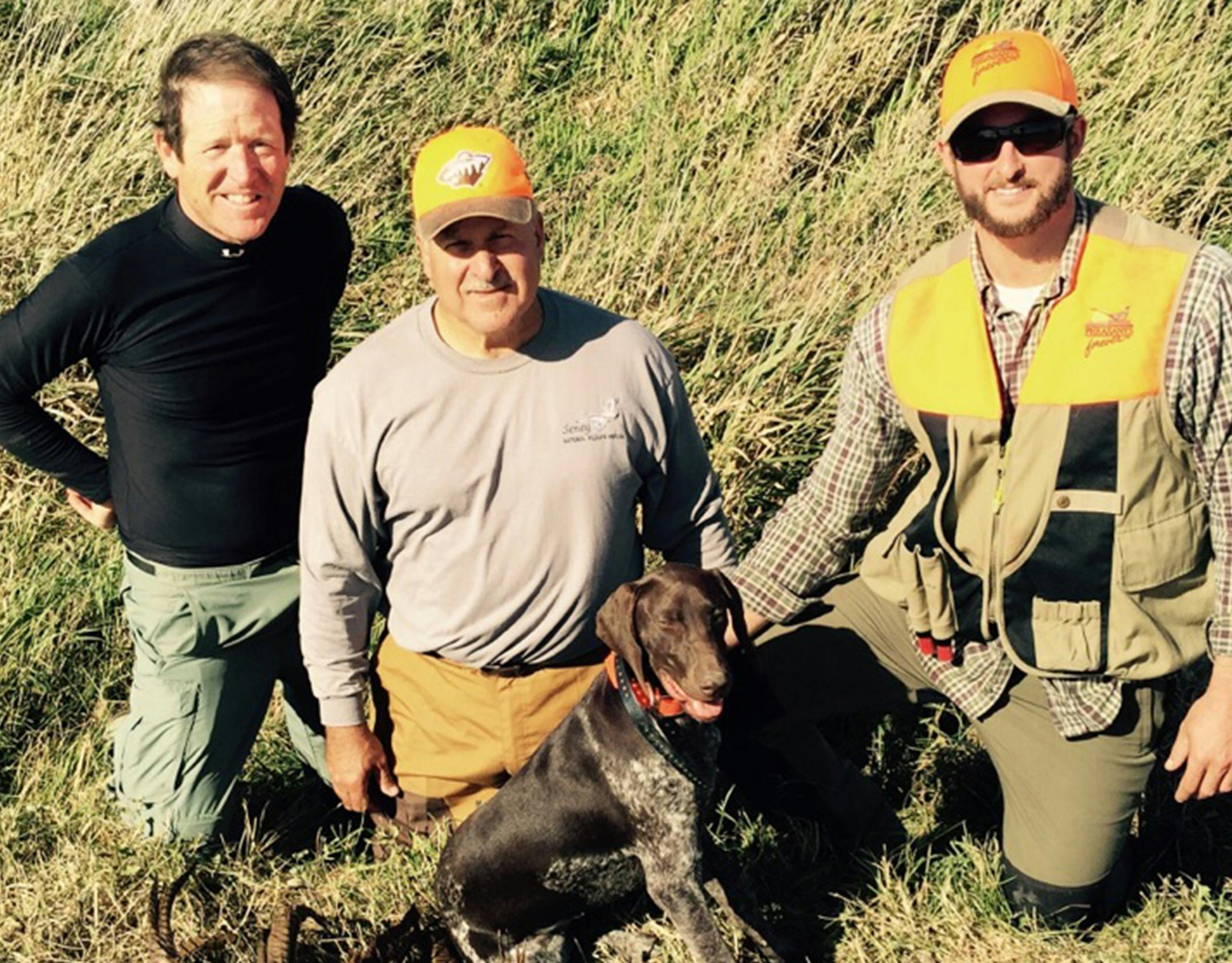 A life-long angler and hunter, Jim Leach, center (past Minnesota Fish and Wildlife director, 2016-19), ended a day of pheasant and duck hunting last fall near Windom, Minn. He's flanked by son Brian (right) and a high school friend, Dr. Jim Finell (left) and Brian's dog, Ruby.